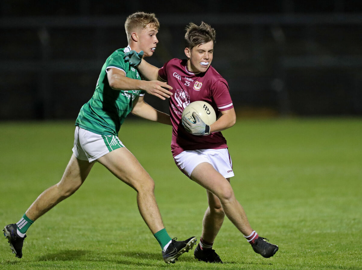 David O'Leary, Ballincollig, and Darragh Griffin, Bishopstown, battling in the Challenge Cup final at Páirc Uí Rinn. Picture: Jim Coughlan.