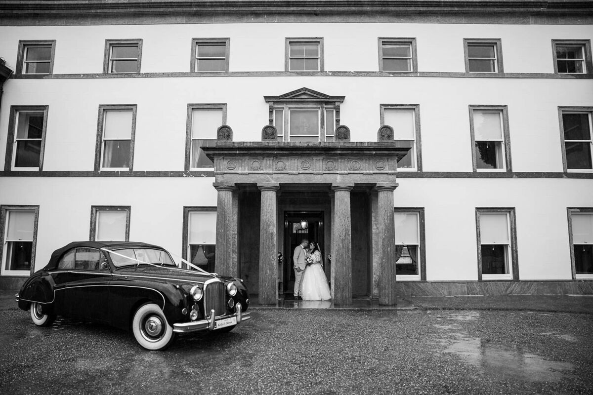 The couple outside Fota House, with one of their wedding cars from Mercier Vintage Cars. The rain was “pouring down,” on the day, thanks to Storm Betty. The couple outside Fota House, with one of their wedding cars from Mercier Vintage Cars. The rain was “pouring down,” on the day, thanks to Storm Betty.