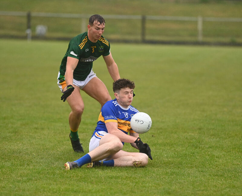  Luke Murphy, Cullen, loses his footing in the wet conditions as Cobh full-back Timmy Wilk defends. Picture: Larry Cummins