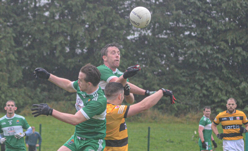 Macroom's Blake O'Gorman and Sean Kiely jump for a high ball with Na Piarsaigh's Patrick Rourke. Picture: Howard Crowdy Macroom's Blake O'Gorman and Sean Kiely jump for a high ball with Na Piarsaigh's Patrick Rourke. Picture: Howard Crowdy
