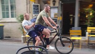 <p class="contextmenu internal_Caption">Peter O’Mahony and Keith Earls riding a bike together through the French streets. Picture: Twitter</p>