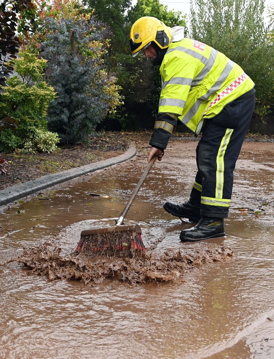 Firefighter David O'Leary of Macroom Fire Brigade helping to clear a drain after a flash flood following heavy rain at Killumney, Co. Cork, during Storm Agnes. Picture Denis Minihane. Firefighter David O'Leary of Macroom Fire Brigade helping to clear a drain after a flash flood following heavy rain at Killumney, Co. Cork, during Storm Agnes. Picture Denis Minihane.