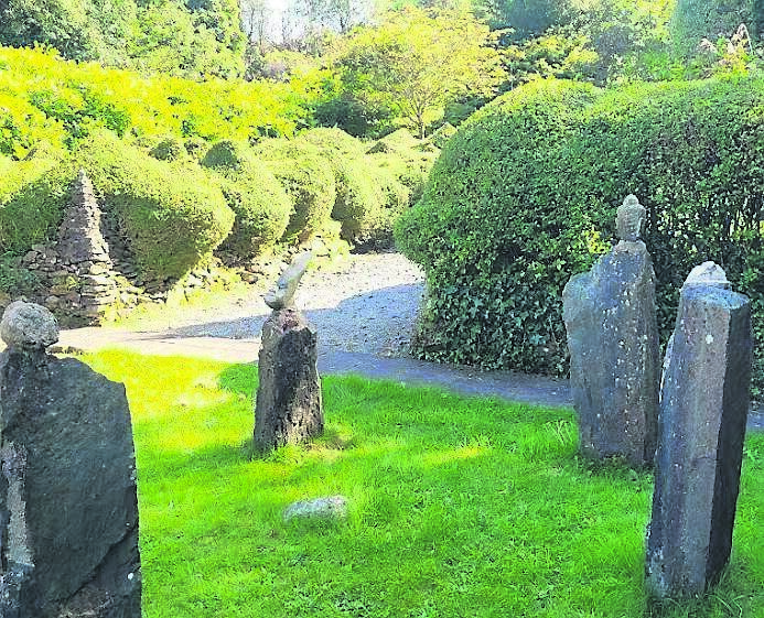 The standing stones located to the rear of the garden surrounded by topiary.