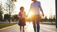 first day at school. mother leads  little child school girl in first grade
