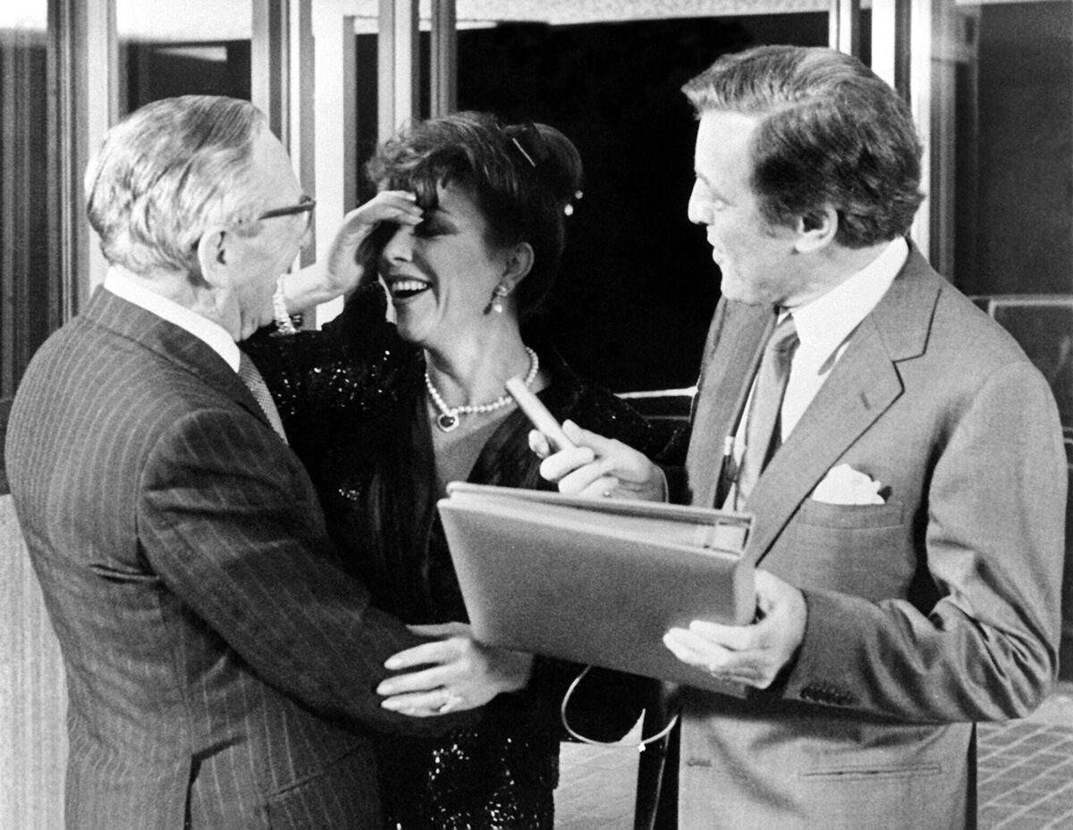 This is Your Life presenter Eamonn Andrews (left) presenting actress Joan Collins, pictured with her father Joe Collins on his 80th birthday, with the Big Red Book in London. This is Your Life presenter Eamonn Andrews (left) presenting actress Joan Collins, pictured with her father Joe Collins on his 80th birthday, with the Big Red Book in London.