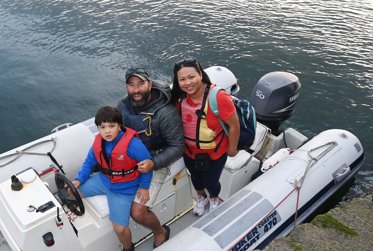 Amm and Kevin McCormack after arriving by boat at Cunnamore pier from Heir Island in West Cork with their son Finn on his way to school. Amm and Kevin McCormack after arriving by boat at Cunnamore pier from Heir Island in West Cork with their son Finn on his way to school.