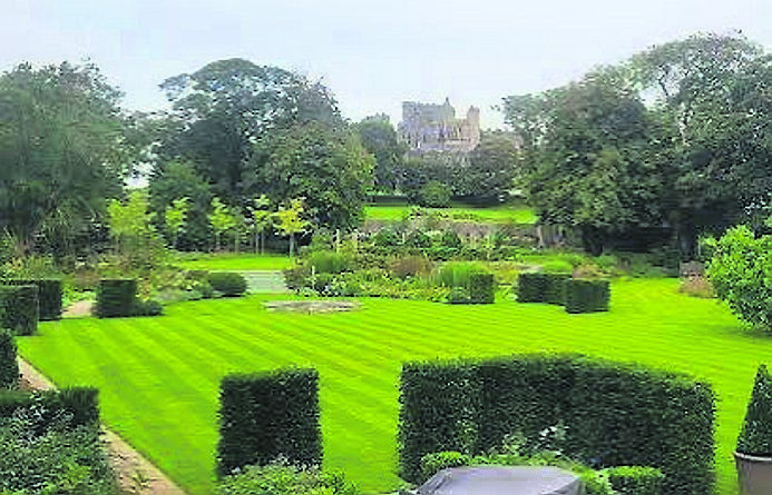 An overview of The Cashel Palace Hotel gardens looking towards The Rock of Cashel with the Mulberry tree on the right hand side