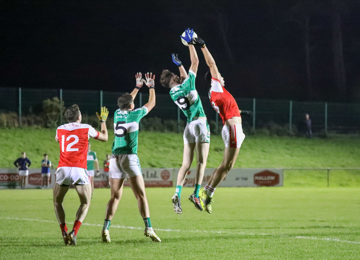 Aghabullogue's Colm Gillespie outjumps Adam Buckley during the IAFC semi-final match between Aghabullogue and Dromtarriffe. Picture: David Creedon
