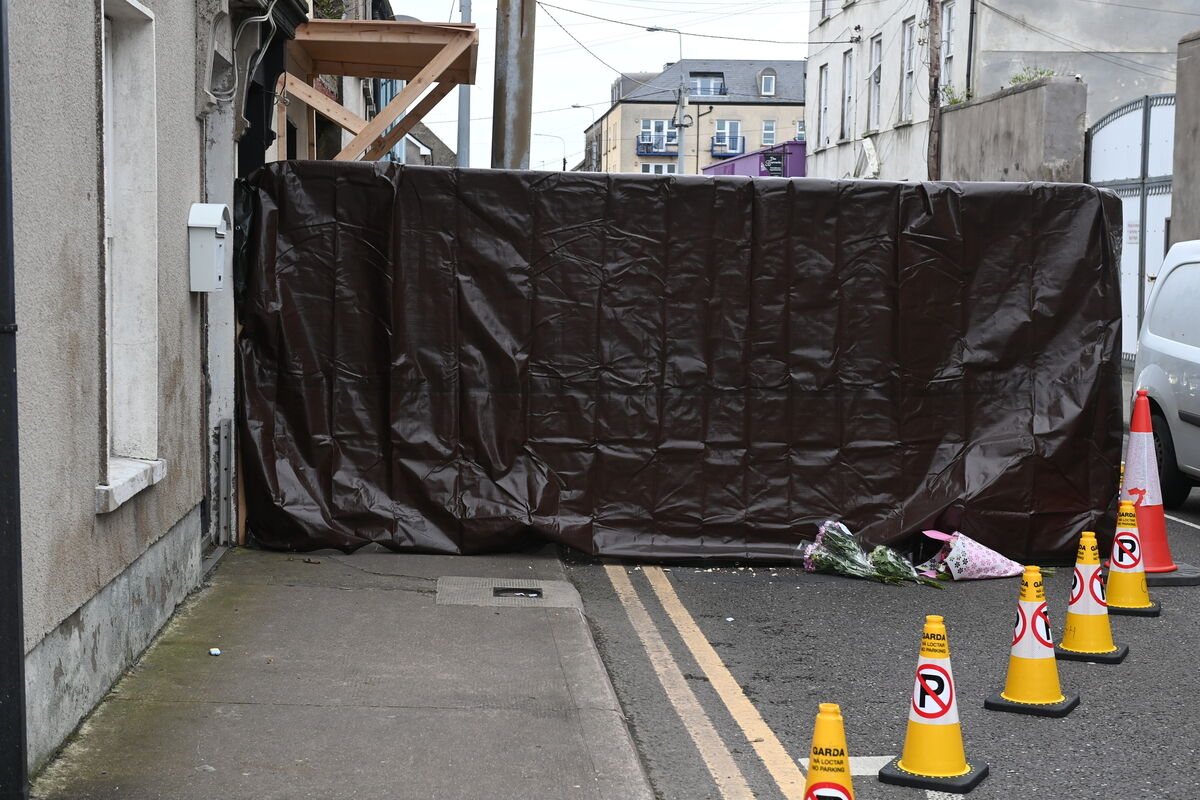 Flowers left at the scene on Grattan Street, Youghal Co Cork where skeletal remains were found at a premises. Pic: Larry Cummins Flowers left at the scene on Grattan Street, Youghal Co Cork where skeletal remains were found at a premises. Pic: Larry Cummins