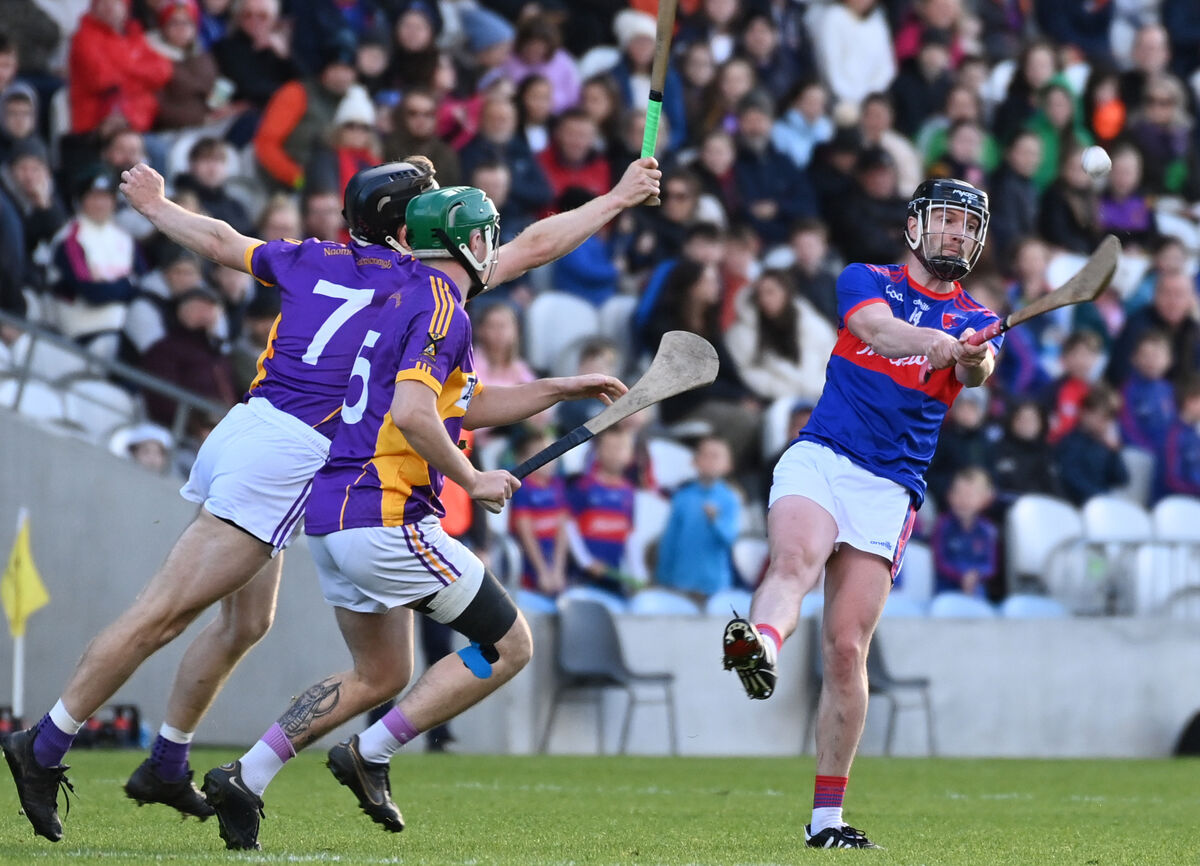 Erin's Own's James McMahon shoots from St. Catherine's Eoin Wallace and Conor Hegarty. Picture: Eddie O'Hare