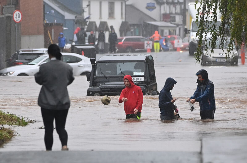 Youngsters with their dog and footballs along with stranded cars outside Sarsfields GAA pitch in Riverstown yesterday. Picture; Eddie O'Hare Youngsters with their dog and footballs along with stranded cars outside Sarsfields GAA pitch in Riverstown yesterday. Picture; Eddie O'Hare