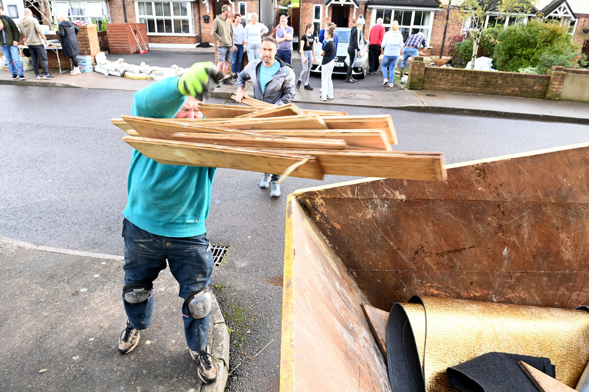  Residents fill a skip with flood damaged items from their homes after Storm Babet hit on Wednesday. The residents of Copper Valley Vue in Glanmire faced a major cleanup after flood water hit their homes. The response from Cork City Council has been poor they say, and they were relying on 'donated' disposal skips to clear the discarded items from their homes. Pic Larry Cummins