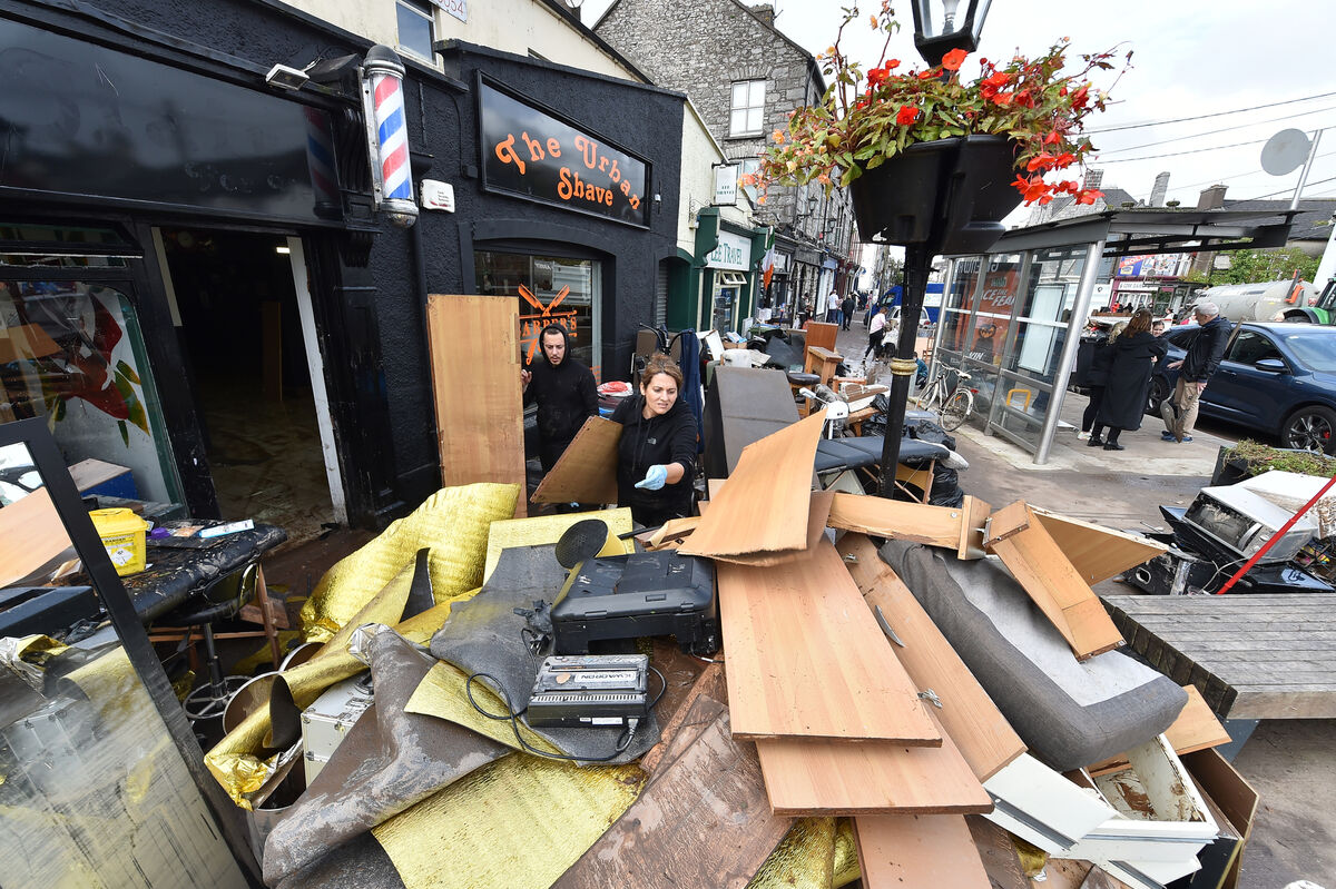  Lia Vaz cleaning up at The Urban Shave which had been renovated six months ago and is now destroyed by the flooding in Midleton, Co Cork. Picture Dan Linehan