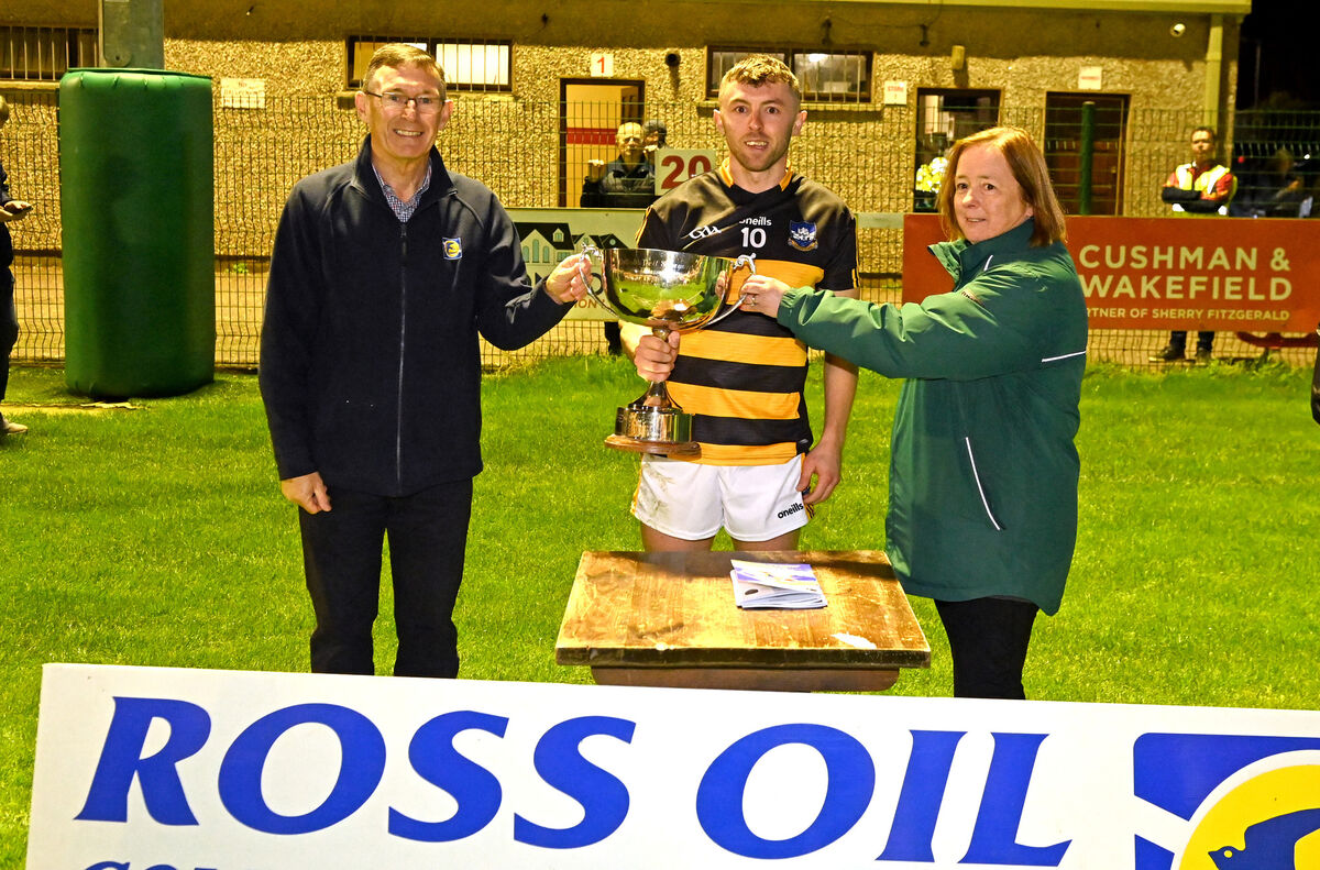 Tim Holland, Ross Oil, and Anne O'Riordan, Muskerry PRO, present the trophy to Canovee captain James Moynihan. Picture; Eddie O'Hare Tim Holland, Ross Oil, and Anne O'Riordan, Muskerry PRO, present the trophy to Canovee captain James Moynihan. Picture; Eddie O'Hare