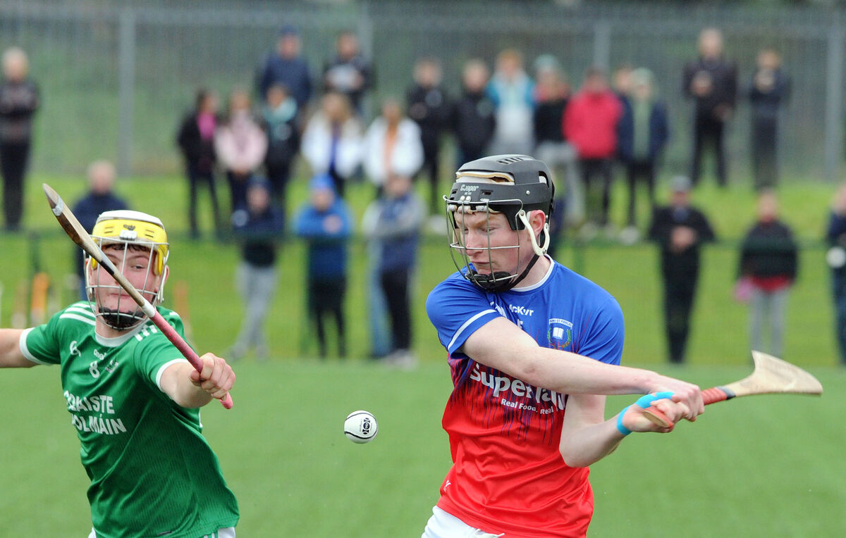 St Colman's Donnacha Hickey trying to block down a shot by Pobalscoil na Tríonóide's Harry McGann in the Harty Cup at Bishopstown. Picture: Denis Minihane