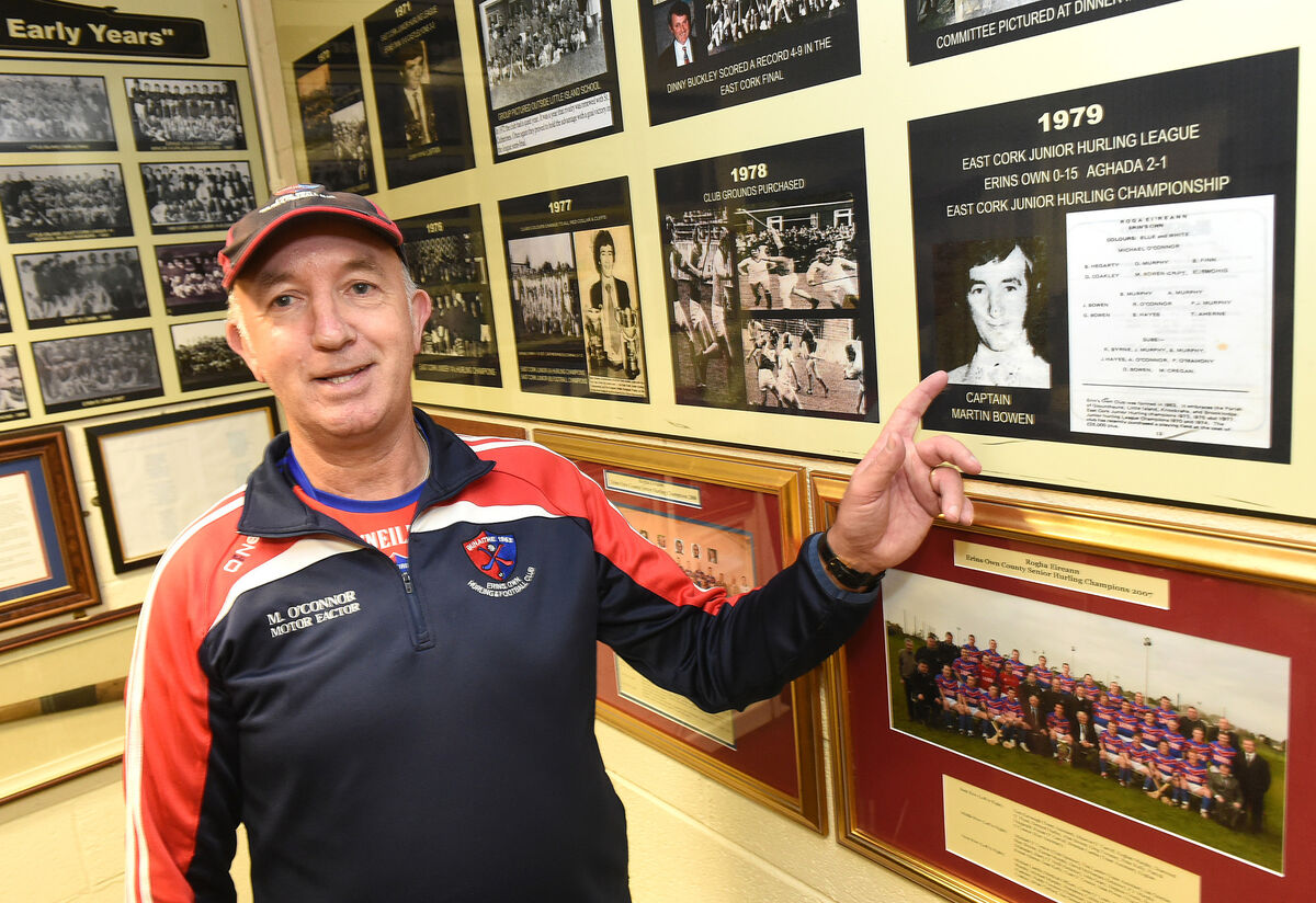 Martin Bowen points to photo of himself as captain of the winning team in the East Cork Junior Hurling Championship in 1979.