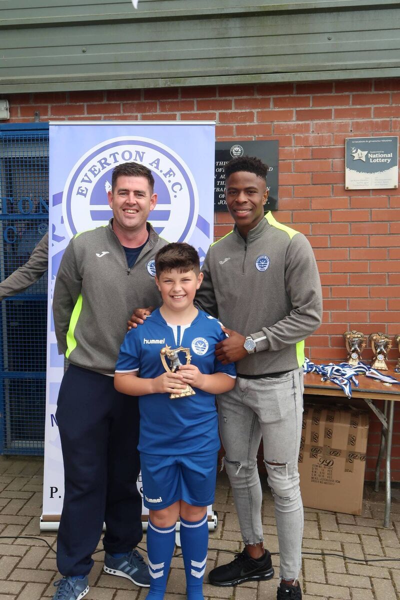 Ryan Gahan shows off the Everton U11 Player of the Year award, with manager Keith Gahan and former Everton youth player Chiedozie Ogbene.