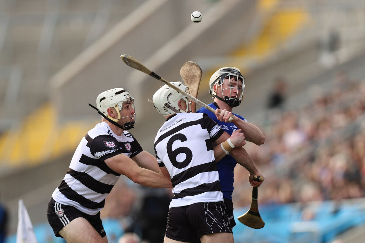 Sarsfields’ Jack O'Connor is challenged by Sean O'Leary Hayes and Tommy O'Connell of Midleton. Picture: ©INPHO/Tom Maher