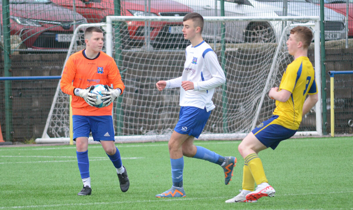 Leeds goalkeeper Andrew Demtriche gathers the ball ahead of Douglas Hall's Rob O'Leary and team mate Stephen Daly during the recent U17 Premier league match in Moneygourney. Pictiure: Howard Crowdy