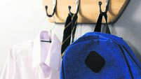 School uniform and schoolbag hanging on hook
