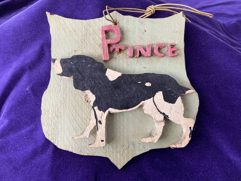 A plaque, of his dog Prince, made by Tim Cagney