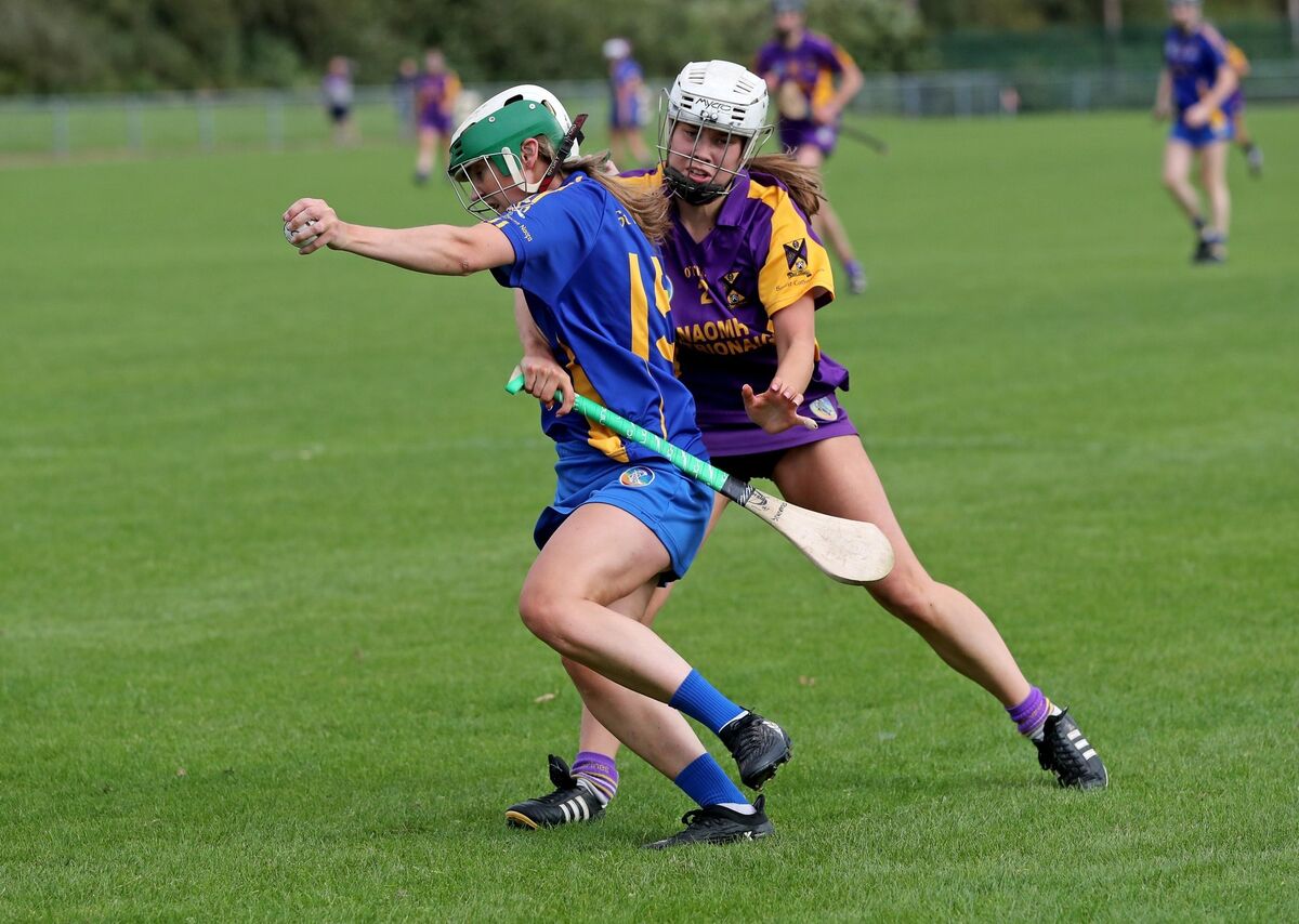Cliona Dunning, St Catherine's, tries to hold up Caroline Sugrue, St Finbarr's. Picture: Jim Coughlan. Cliona Dunning, St Catherine's, tries to hold up Caroline Sugrue, St Finbarr's. Picture: Jim Coughlan.