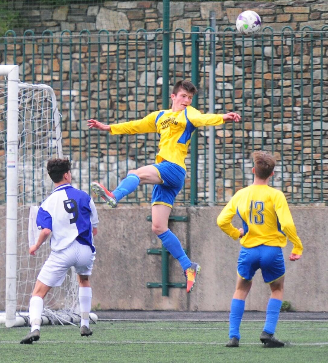 Carrigaline United's Josh Honohan heading the ball out of defence against College Corinthians. Picture: Denis Minihane.