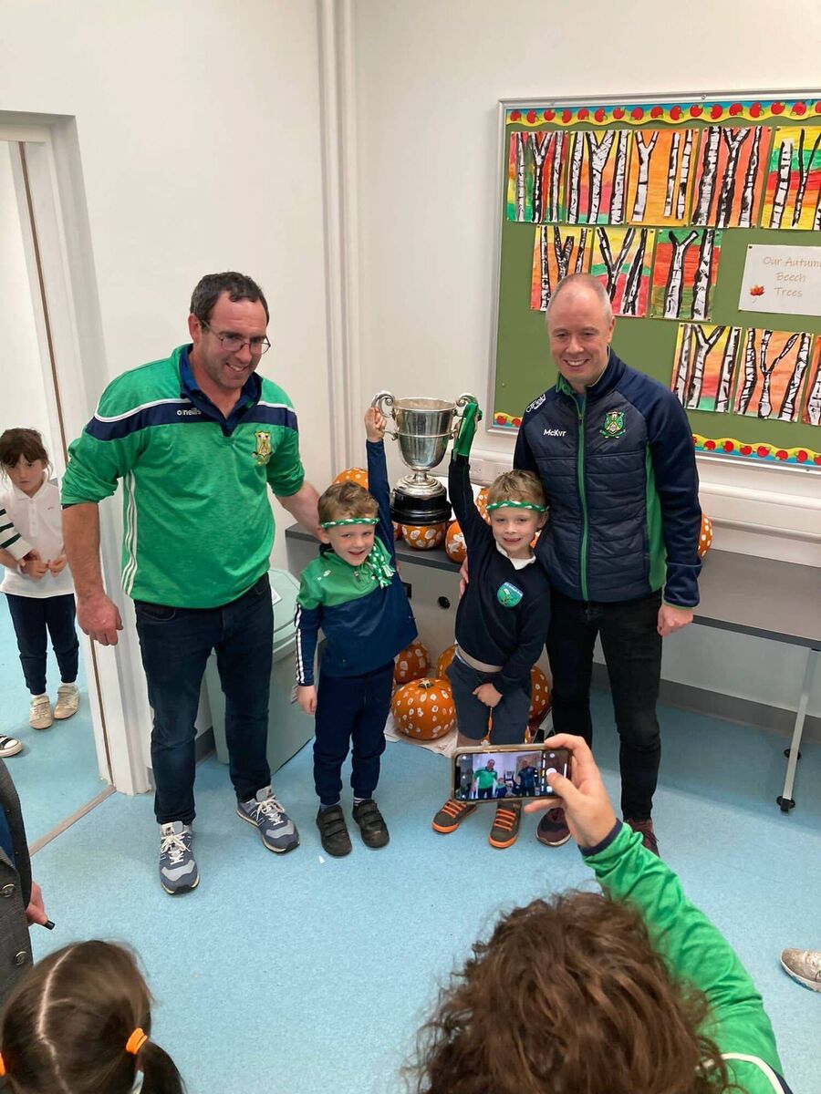Junior infant pupils Seán O Leary and Michael McGrath with the trophy and Micheál McGrath (hurling team manager) and Tim O Leary (Seáns dad). Junior infant pupils Seán O Leary and Michael McGrath with the trophy and Micheál McGrath (hurling team manager) and Tim O Leary (Seáns dad).