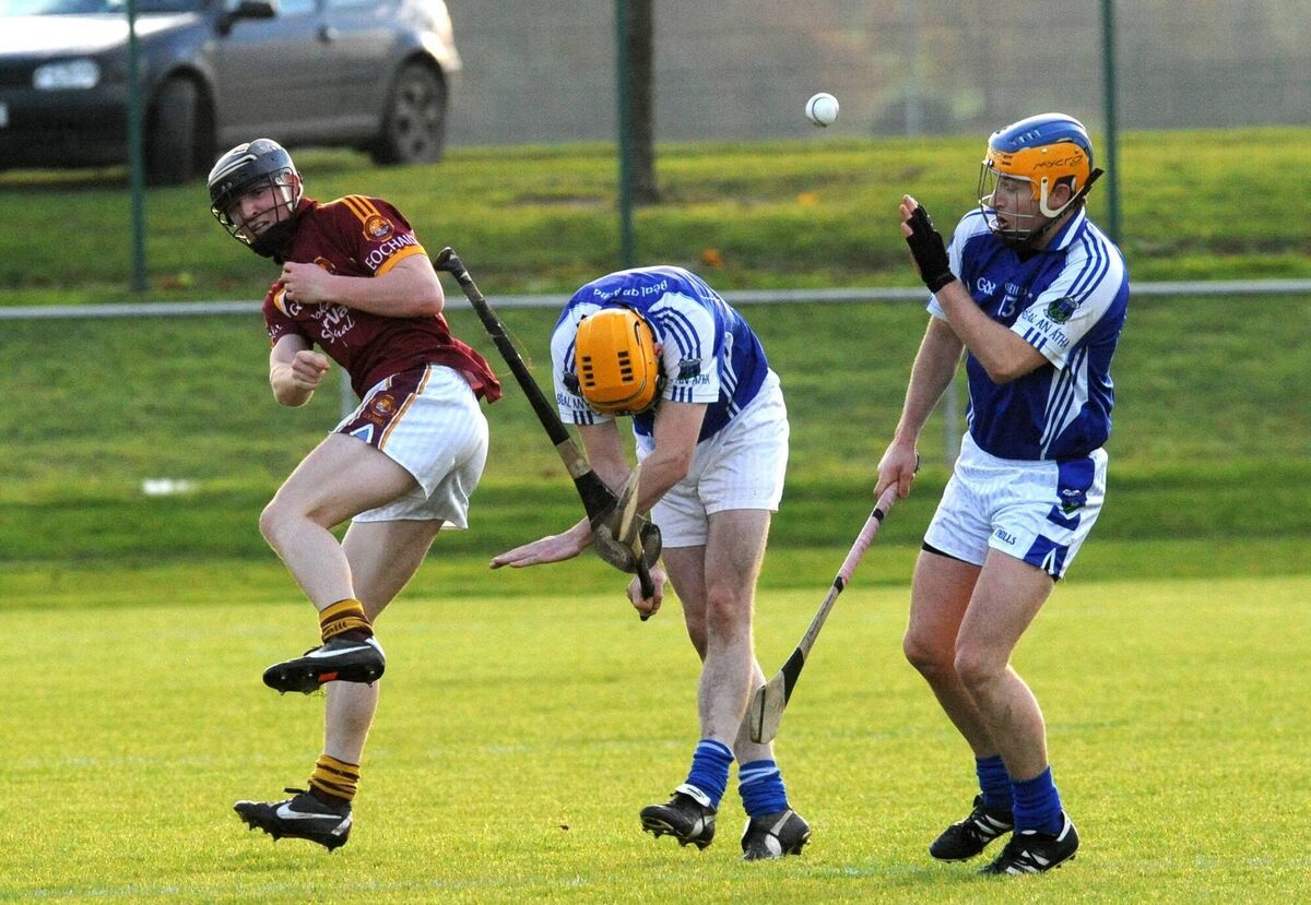 Youghal defender Michael Cronin clears past Ballina players Jerry O'Brien and David Hickey in the Minster final. Picture: Des Barry