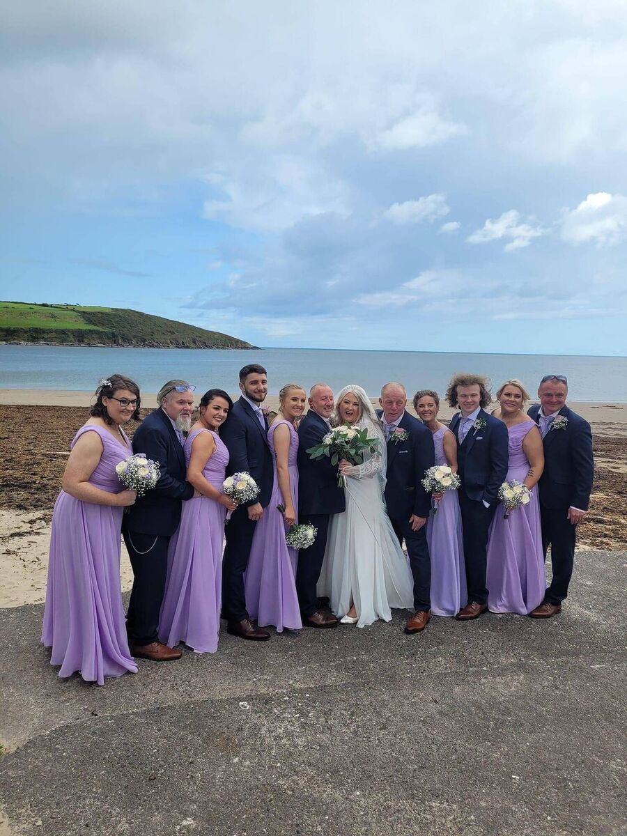 The couple with their wedding party, which was made up of family and friends. They had their wedding back in August.