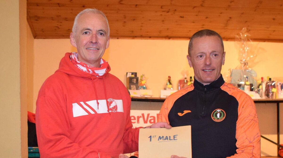 Barry Twohig, winner of the Eyeries five-mile road race, receiving his prize from Mark Gallagher of Beara AC. Picture: John Walshe Barry Twohig, winner of the Eyeries five-mile road race, receiving his prize from Mark Gallagher of Beara AC. Picture: John Walshe