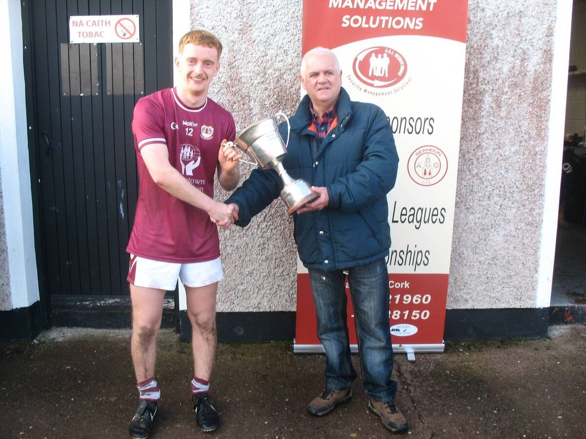 Seandún Chairman Michael Higgins presents the Seandún U21A Football Championship trophy to Bishopstown winning captain Simon Collins Seandún Chairman Michael Higgins presents the Seandún U21A Football Championship trophy to Bishopstown winning captain Simon Collins