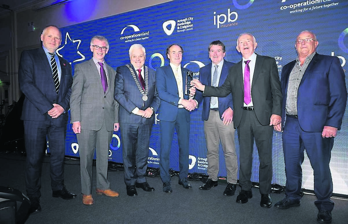 IPB Insurance chairman John Hogan and Co-operation Ireland’s Trevor Ringland present the award for Community Wellbeing Initiative: Holistic, to winning representatives from Banteer, Co Cork. IPB Insurance chairman John Hogan and Co-operation Ireland’s Trevor Ringland present the award for Community Wellbeing Initiative: Holistic, to winning representatives from Banteer, Co Cork.
