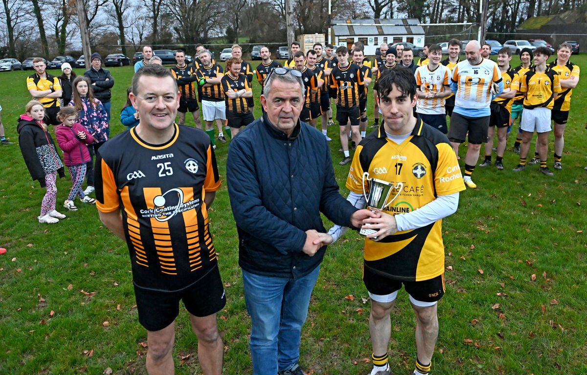 Matthew McAuliffe, brother of the late Pat McAuliffe, presenting the Pat McAuliffe Memorial Trophy to the winning captain Richard Murphy after Richie's Rebels defeated Sully's All-Stars at Rochestown College. Picture: Eddie O'Hare