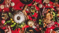 Flat-lay of friends eating and talking at festive Christmas table