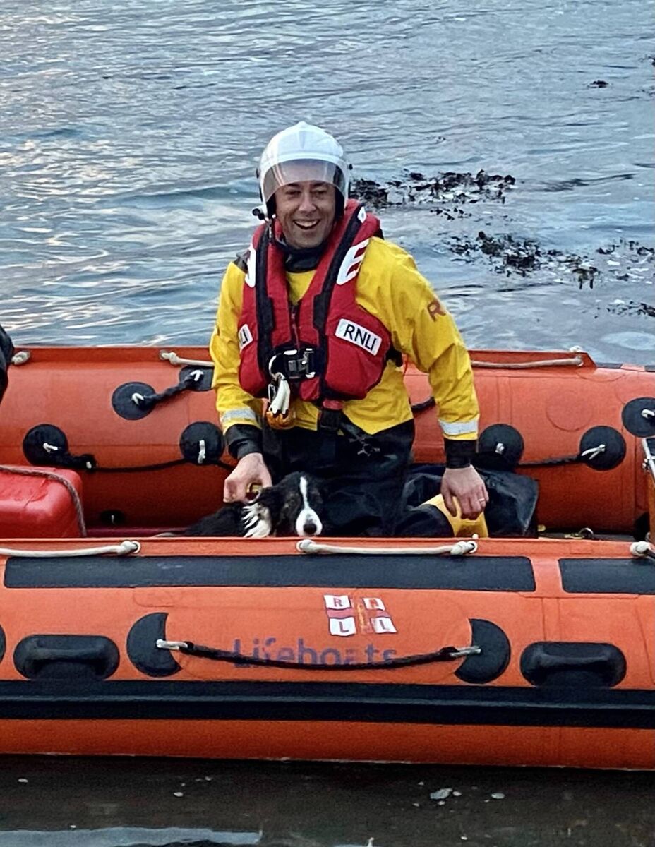 Mark John Gannon as he brings dog Bonnie to safety Mark John Gannon as he brings dog Bonnie to safety