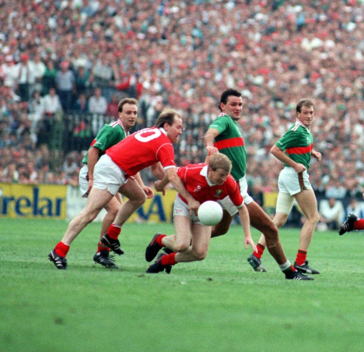 Dinny Allen receives assistance from Dave Barry as Mayo's Liam McHale tries to put them under pressure.