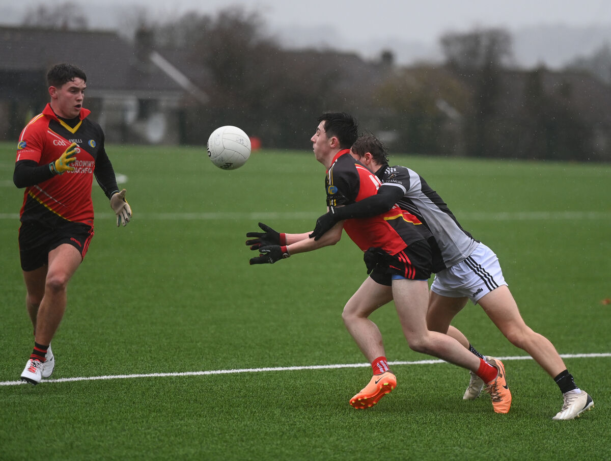 Gavin Coleman passes to Ryan Delaney of Coachford College under pressure from Neville O'Shea, St Francis College Rochestown in the Corn Uí Mhuirí at Bishopstown. Picture: Larry Cummins