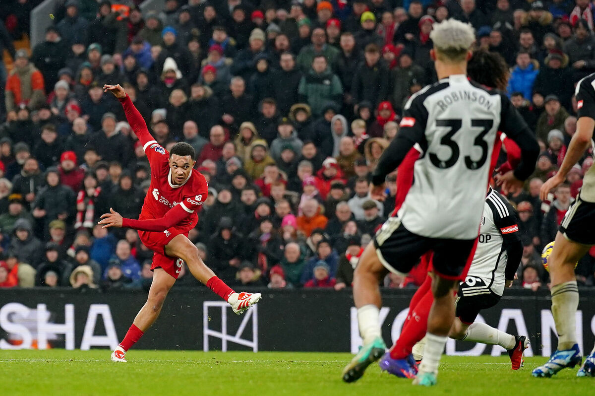 Liverpool's Trent Alexander-Arnold (left) scores his sides fourth goal of the game against Fulham at Anfield. Picture: Peter Byrne/PA Wire.