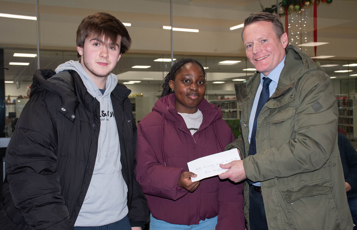 Sean McCarthy presents the Billy McCarthy Award to Blessings Gwarimbo from Carrigaline with Sean Varian O'Driscoll as runner up at the recent Douglas Writers Club anniual Awards Night in the Douglas Library. Picture: Howard Crowdy