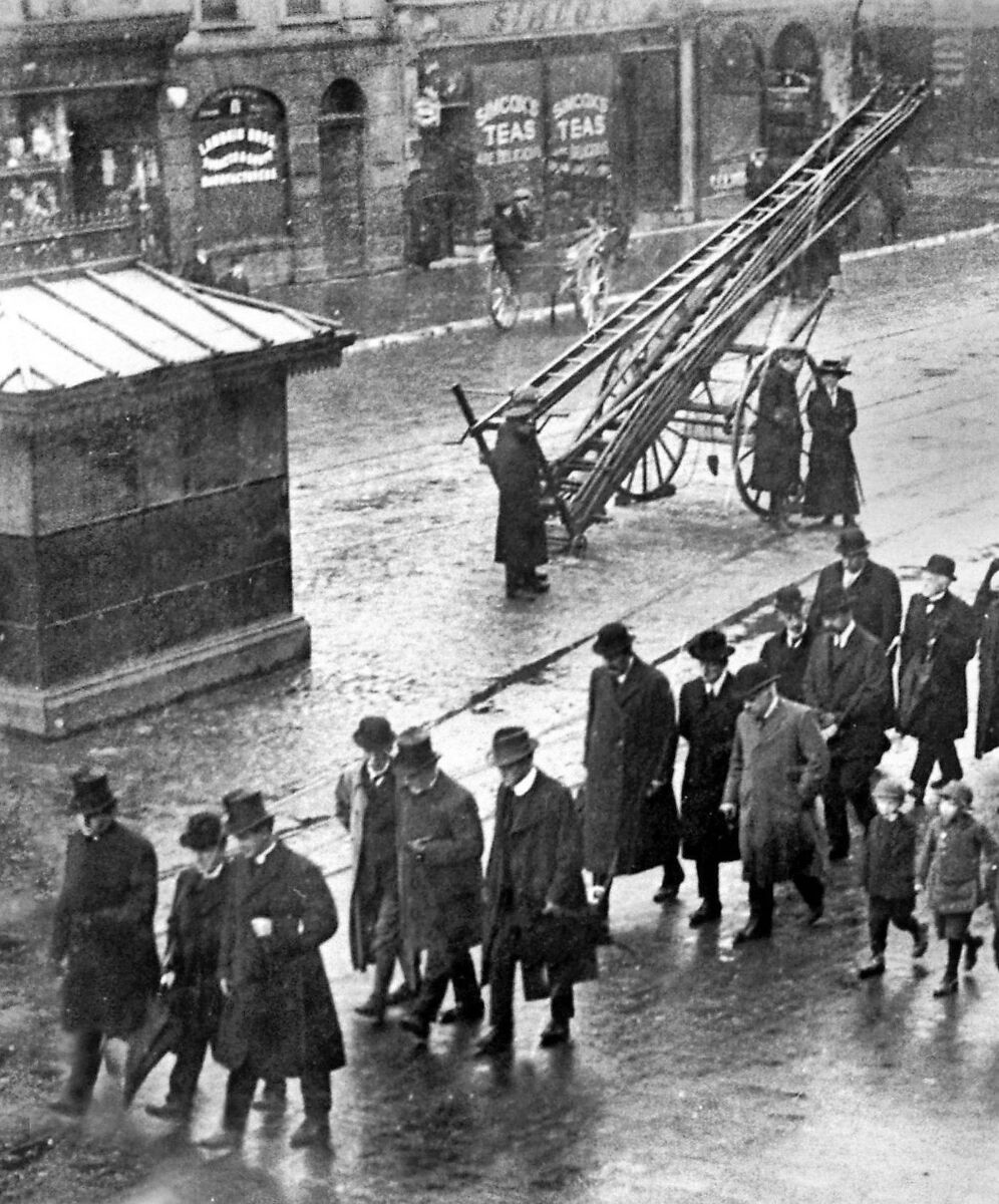 Fireman's rest: A religious procession passes the Fireman's Rest at Patrick's Street, Cork in 1915. Note the wheeled escape stationed nearby. Fireman's rest: A religious procession passes the Fireman's Rest at Patrick's Street, Cork in 1915. Note the wheeled escape stationed nearby.