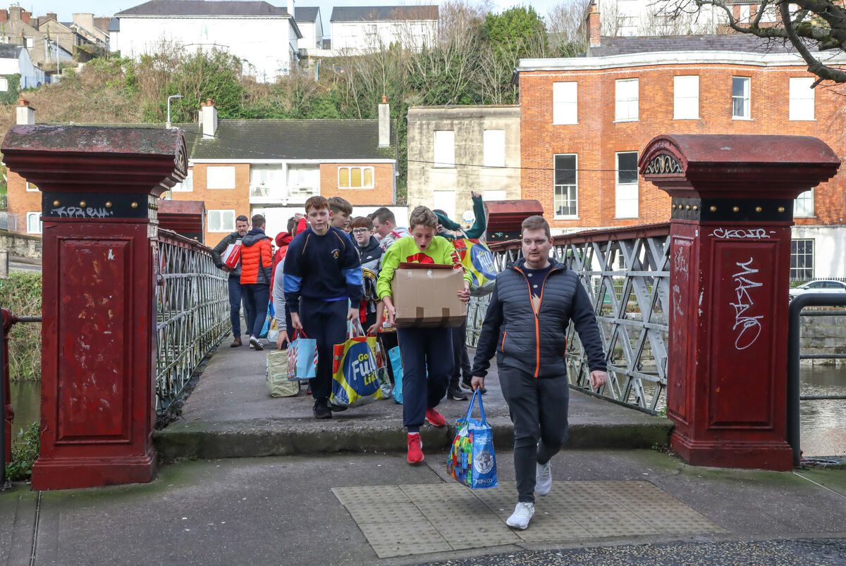 Pupils from Blarney Street National School set off on a walk, carrying bags of food donations that they collected for Penny Dinners on Little Hanover Street, Cork.- Picture: David Creedon