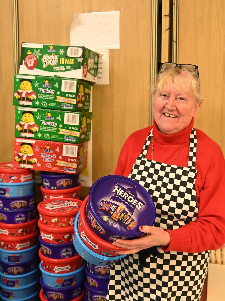 Caitríona Twomey with donated chocolates and boxes of crisps Christmas fayre at Cork Penny Dinners. Picture Denis Minihane. Caitríona Twomey with donated chocolates and boxes of crisps Christmas fayre at Cork Penny Dinners. Picture Denis Minihane.