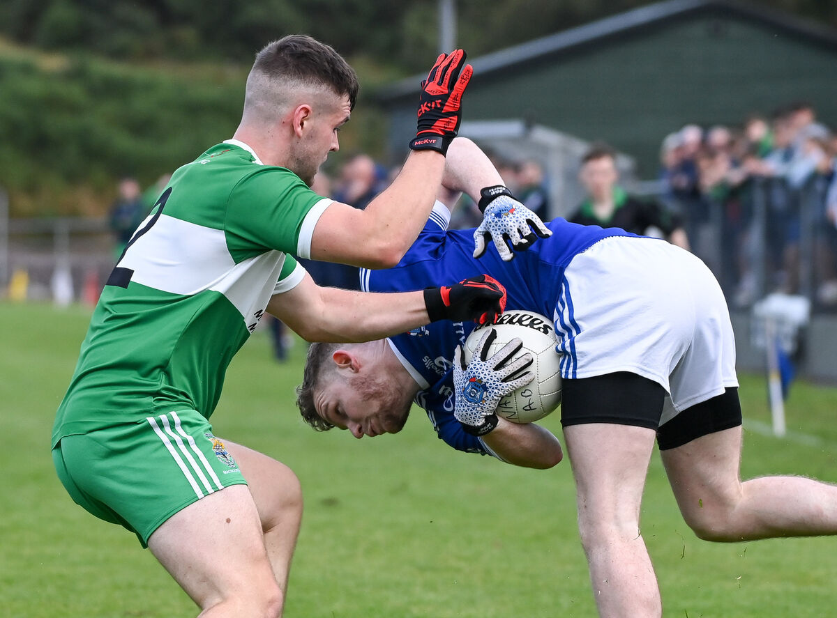 Naomh Abán's Dermot Ó Ceallaigh keeps possession under pressure from Macroom's Ciarán Condon. Picture: David Keane Naomh Abán's Dermot Ó Ceallaigh keeps possession under pressure from Macroom's Ciarán Condon. Picture: David Keane