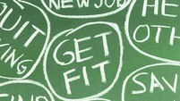 A woman thinking of different New Years resolutions