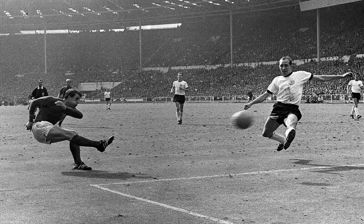 Geoff Hurst shooting the ball past West Germany's Willi Schulz to score England's third goal in extra time of the 1966 World Cup Final at Wembley. Picture: PA