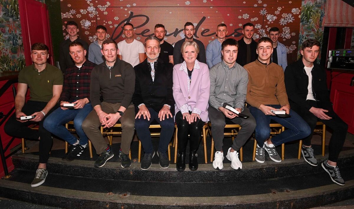  Hurling team players along with Reardens owner Margaret Kenneally, and general manager John Styles, front fourth left, at the Reardens All-Stars awards presentation evening on Washington Street.