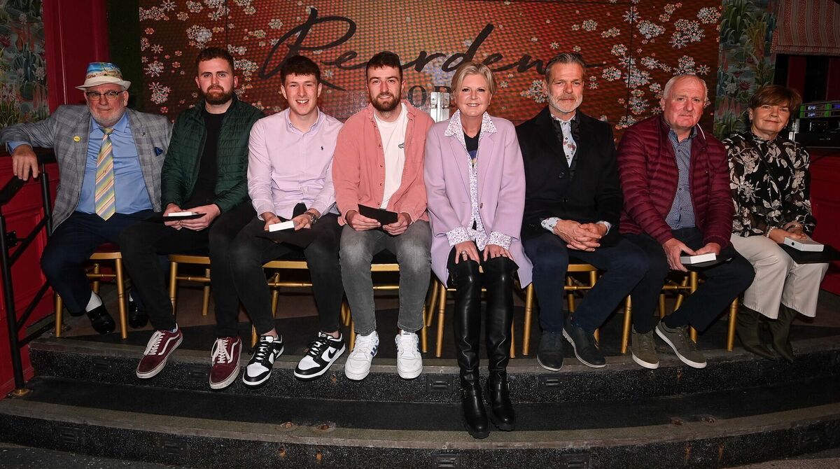  Football team players and player representatives along with Reardens owner Margaret Kenneally, fourth right and general manager John Styles, third right, at the Reardens All-Stars awards presentation evening on Washington Street.