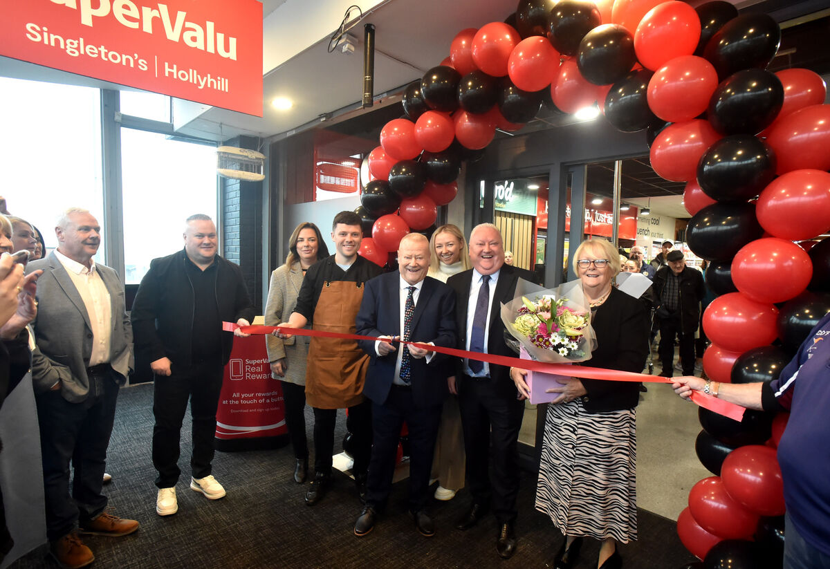 Tom Singleton cutting the tape, with his wife Noreen, sons John, Adrian, Tomas and his wife Emma Singleton and grandchildren Lauren and Jack Singleton at the official opening of the re-vamped Singleton's SuperValu in Hollyhill. Picture; Eddie O'Hare