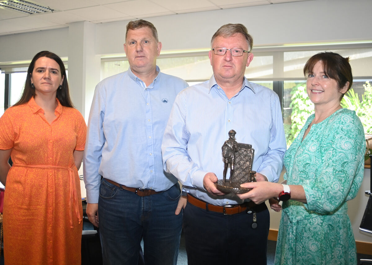  Mark Woods (second from right) being presented with an 'Echo Boy' by Echo editor Gráinne McGuinness to mark his retirement last year. Also pictured are managing director Karen O'Donoghue and sports editor John McHale. Picture: Larry Cummins